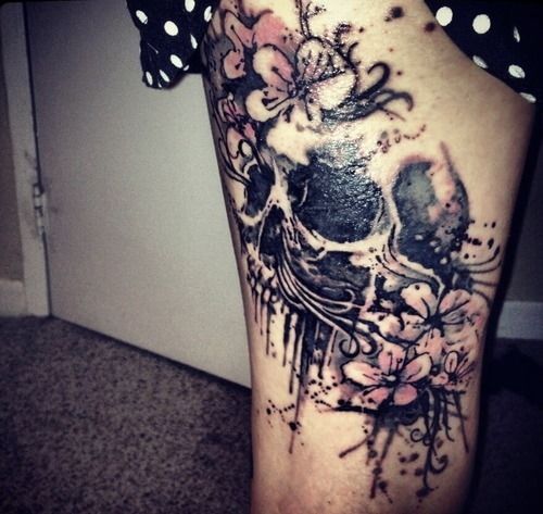 Girl skull and flower tattoo on leg