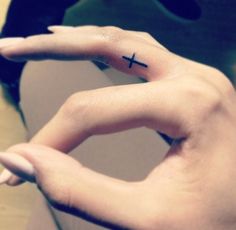 Girl with minimalistic cross tattoo