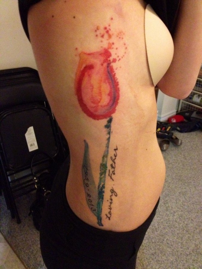 Girl with tulip tattoo on right side