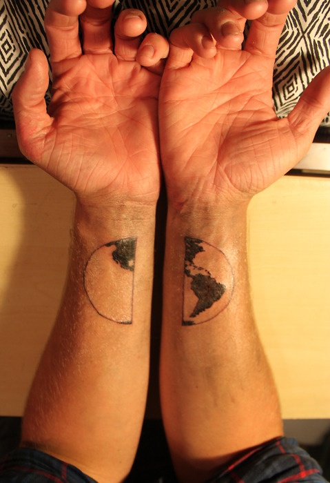 Globe tattoo on both hands