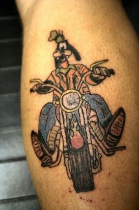 Goofy cartoon bicycle tattoo on leg