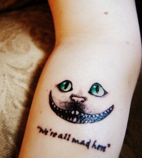 Gorgeous green eye of cat quote tattoo on arm