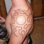 Gorgeous ornamental sun tattoo on shoulder