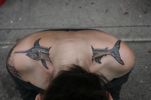 Gorgeous simple fish tattoo on arm