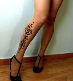 Gorgeous woman flower tattoo on leg