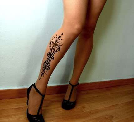 Gorgeous woman flower tattoo on leg