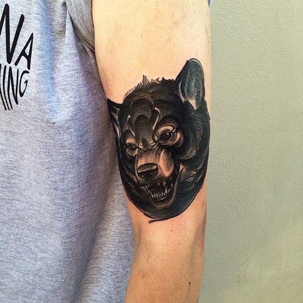 Great look black dog tattoo on arm