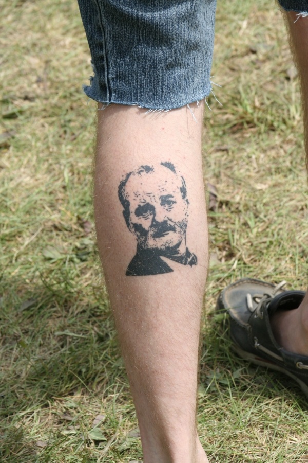 Great men’s face tattoo on leg