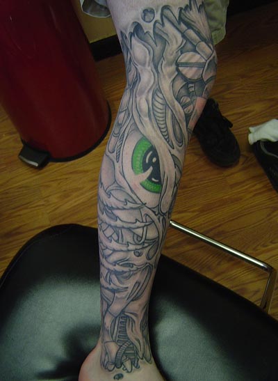 Green amazing eye tattoo on leg