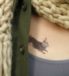 Green jacket and rabbit tattoo on body