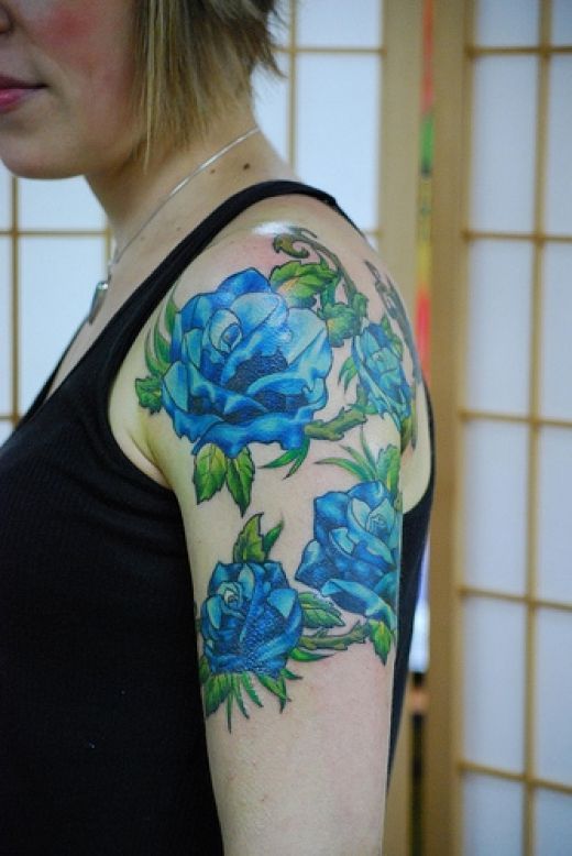 Green leafs and rose blue flowers tattoos