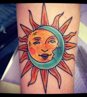 Green moon and yellow sun tattoo on leg