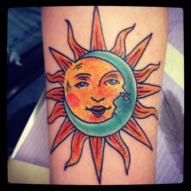 Green moon and yellow sun tattoo on leg