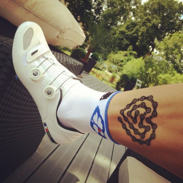 Heart chain bicycle tattoo on leg