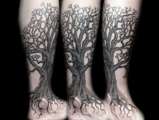 Huge black tree tattoo on leg