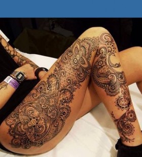 Huge women's lace tattoo on leg