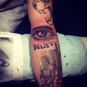 King, believe, tiger and eye tattoo on arm
