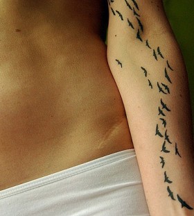 Lotf of little bird tattoo on arm