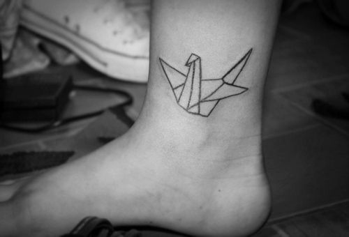 Lovely black origami tattoo on leg