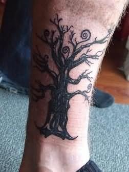 Lovely black tree tattoo on leg