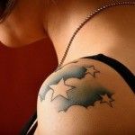 Lovely blue star tattoo on shoulder