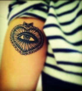 Lovely heart eye tattoo on arm