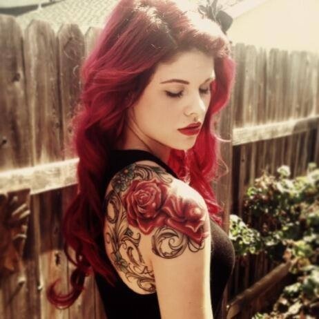 Lovely red hair girl rose tattoo on arm