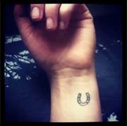 Lovely simple horse shoe tattoo