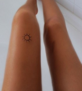 Lovely small sun tattoo on leg