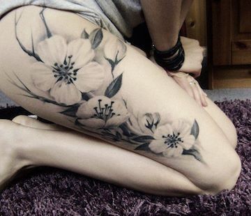 Lovely white flower tattoo on leg