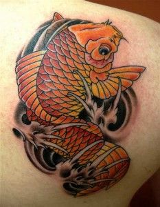 Lovley golden fish tattoo on arm