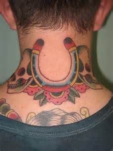 Men's back skull and horse shoe tattoo