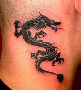 Men's dragon tribal tattoo on shoulder