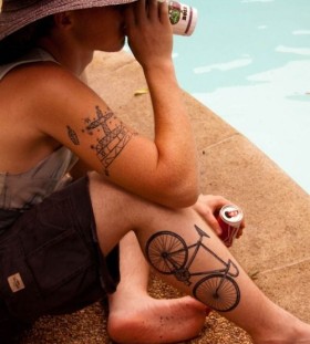 Men's drinking cola and bicycle tattoo on leg