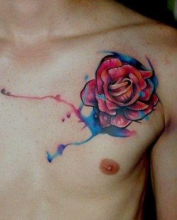 Men's pink flower tattoo on chest