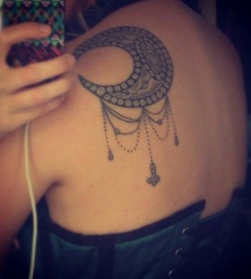 Moon, ornaments and sun tattoo on shoulder