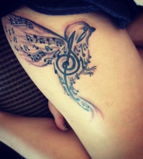Music style bird tattoo on leg