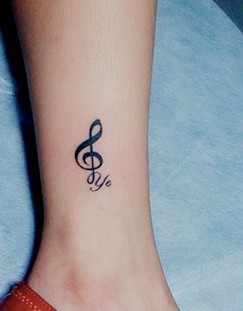 Music style quote tattoo on leg
