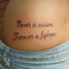 Never a victim forever a fighter quote tattoo on arm