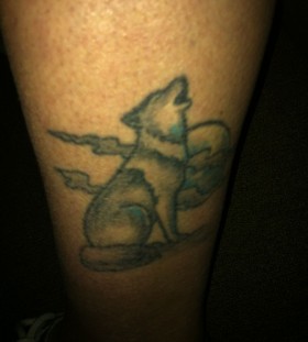 Night and white and black wolf tattoo on leg