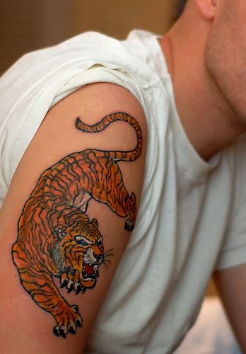 Orange angry tiger tattoo on arm