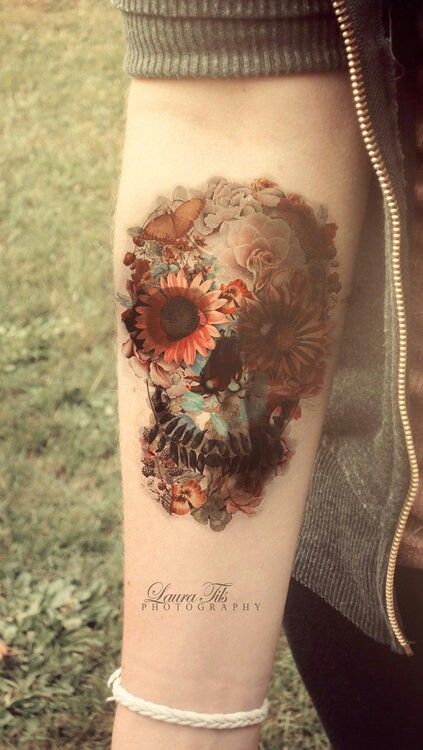 Orange flower and skull tattoo on arm