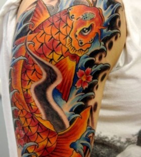 Orange simple fish tattoo on arm