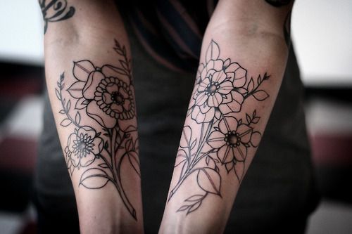 Ornaments and black flower tattoo on hand