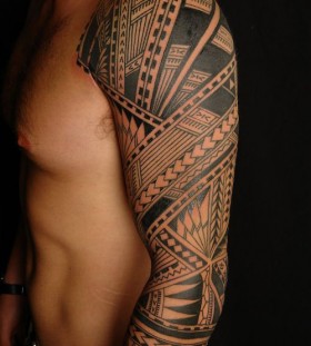 Ornaments and black tribal tattoo on arm