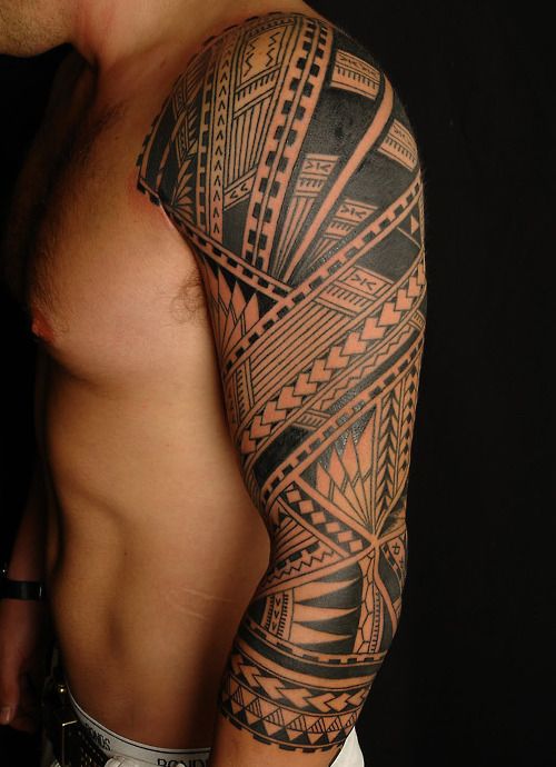 Ornaments and black tribal tattoo on arm