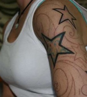 Ornaments and simple star tattoo on arm