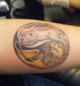 Owal black rabbit tattoo on body