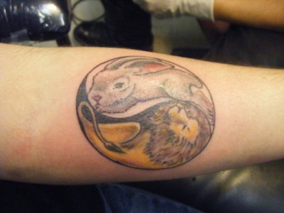 Owal black rabbit tattoo on body