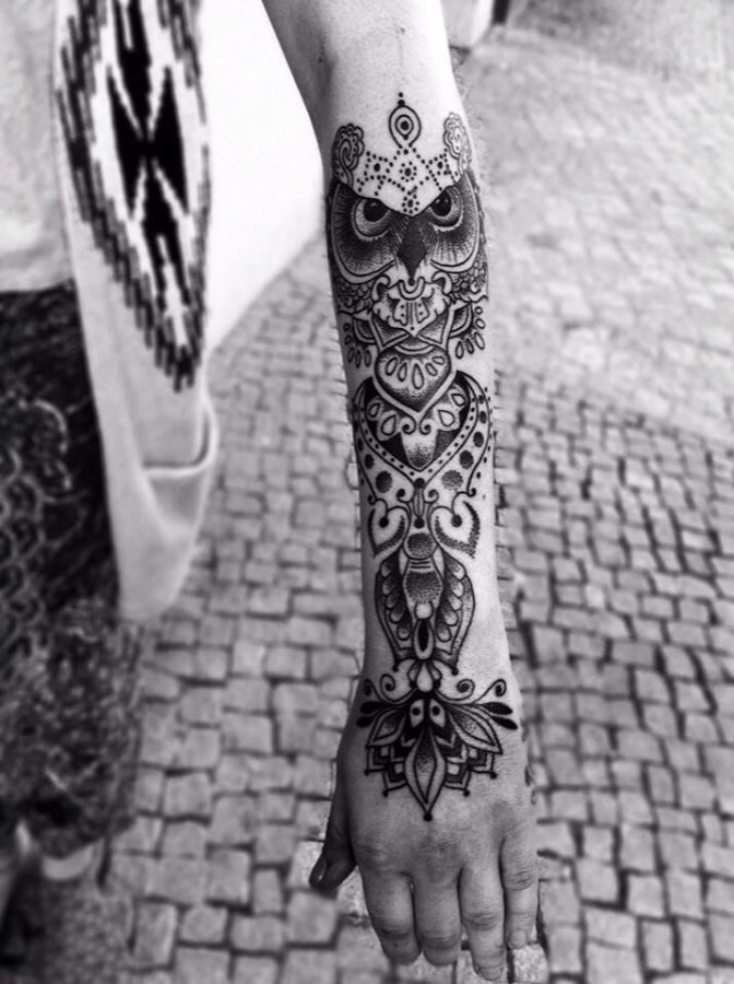 Owl and black lace tattoo on arm